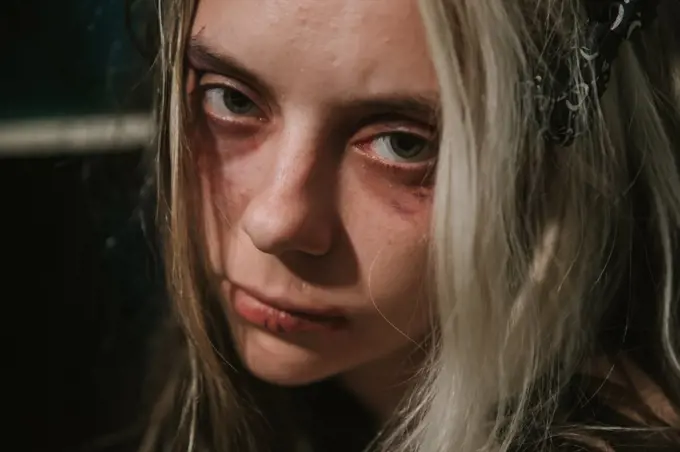 close-up portrait of frightened abused young woman
