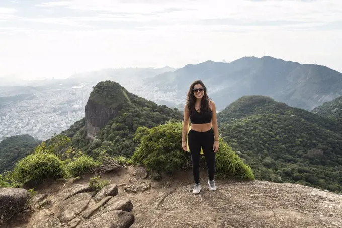 Beautiful view to hiker woman on rainforest mountain landscape