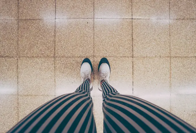 legs of a woman waiting in the subway car