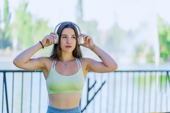 sporty woman listening to music from her headphones