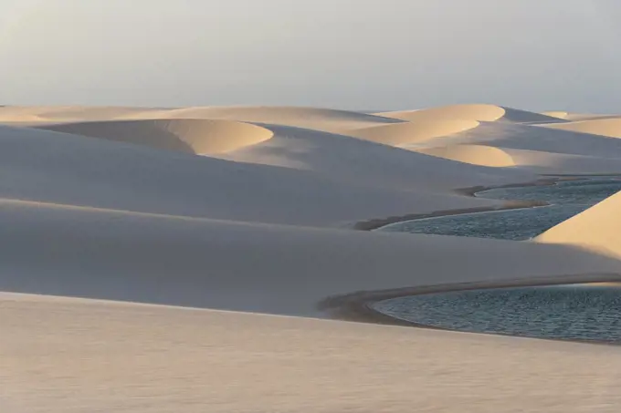 Beautiful view to blue rainwater lagoon on white sand dunes