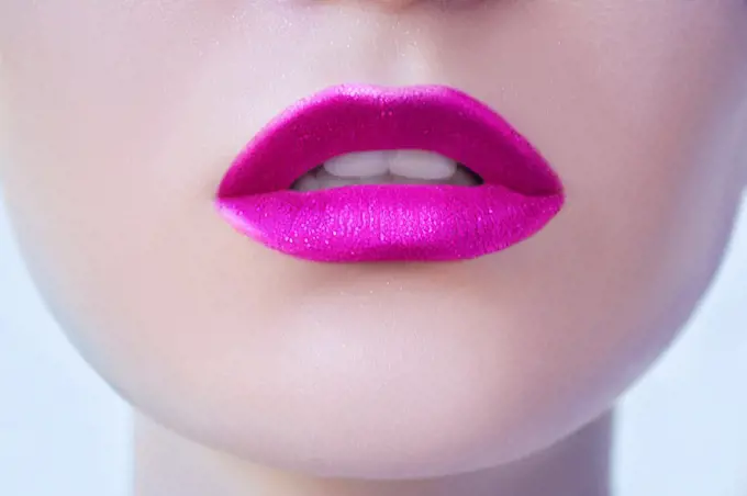 Pink glittery lipstick on lips