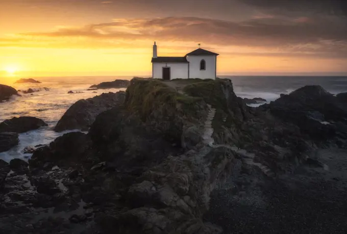 Beautiful hermitage at sunset on the coast of Galicia