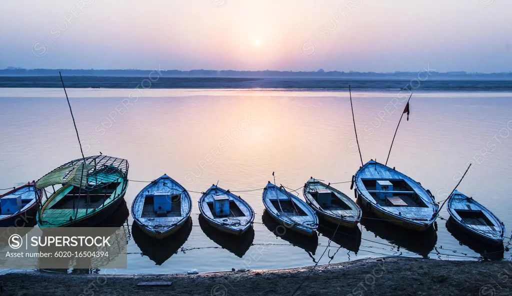 Boats along the Ganges River at sunset in Varanasi, India