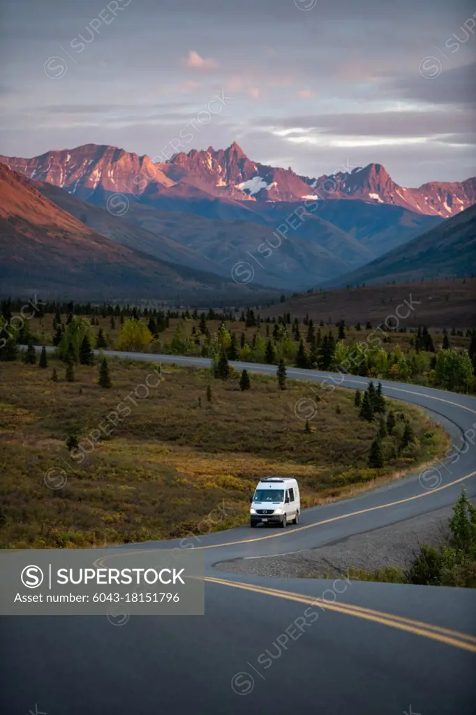 Driving van through Alaska, Denali National Park at sunset, vanlife