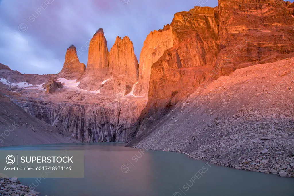Tranquil view of lake and rock formation at Torres Del Paine National Park during magic hour, sunset.