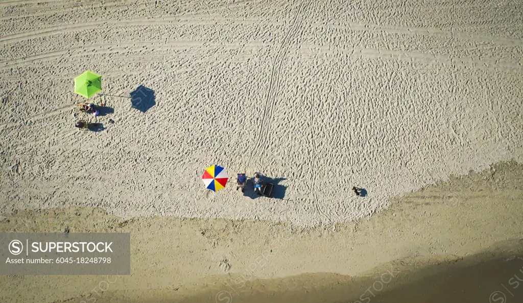 Overhead shot of two umbrellas on a beach