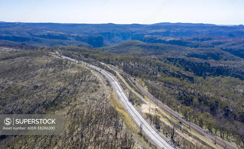Aerial view of the Great Western Highway running through forest burnt by bushfires at Mount Victoria in The Blue Mountains in New South Wales in Australia