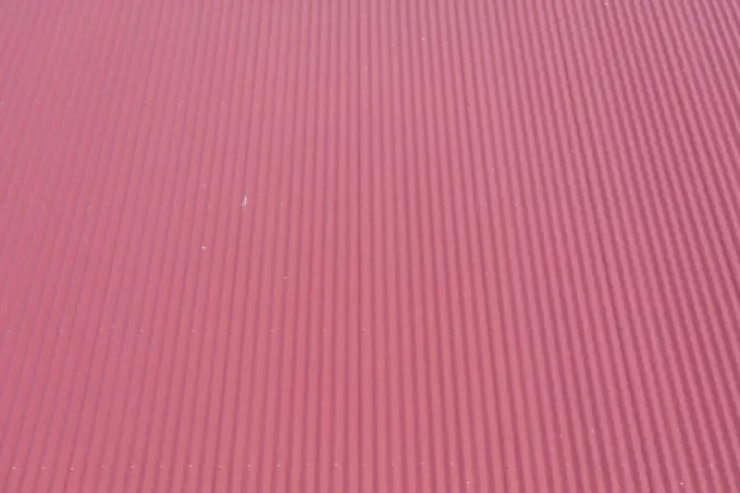 Aerial view of burgundy coloured corrugated iron roof panels