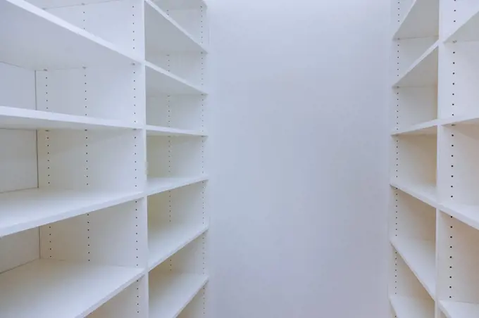 Interior of white shelf or clothing with many empty shelves with installation new home