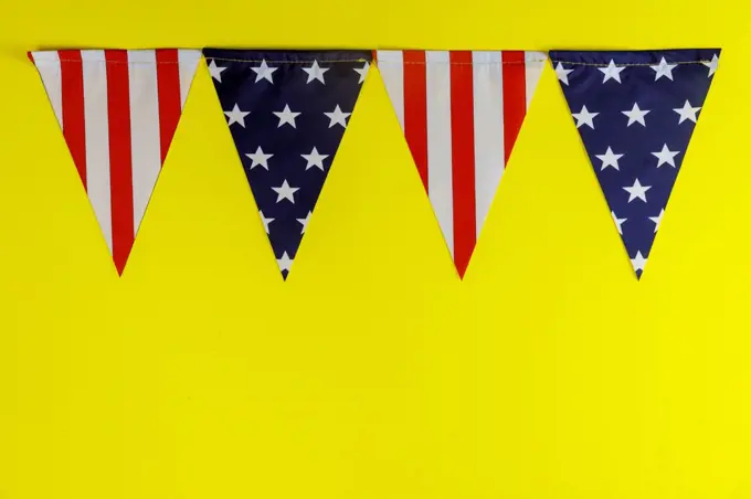 Pennants of stars and stripes flags yellow background american holiday US independence day