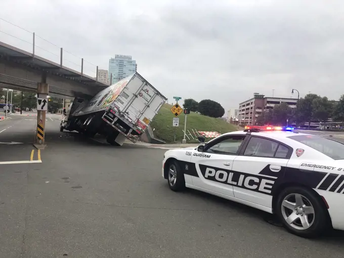 14 September 2019 Durham North Carolina USA Semi trailer truck damaged during the accident hits bridge illuminated police car