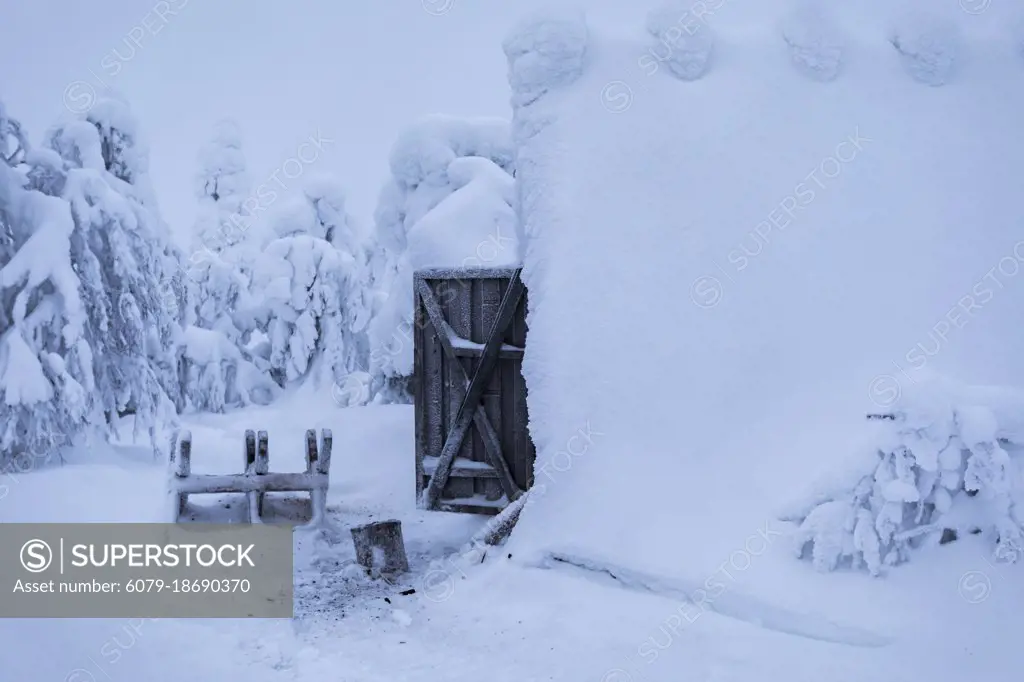 View of a wood shed covered in snow after a blizzard in the Finnish Lapland wilderness. Chocolate Box Winter Scene