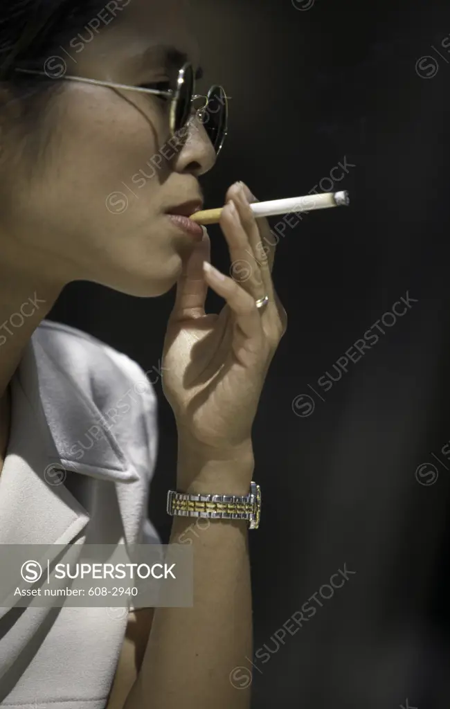 Close-up of a young woman smoking a cigarette