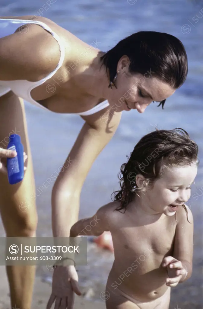Young woman and her daughter at the beach