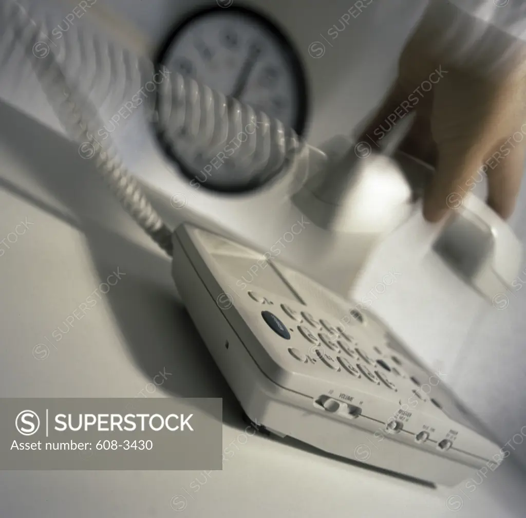 Close-up of a human hand holding a telephone receiver