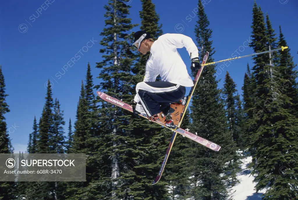 Young man in mid air with skis, Steamboat Springs, Colorado, USA