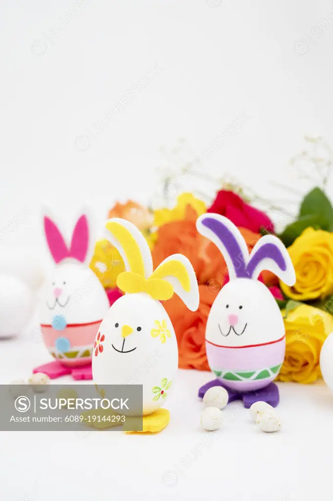 Easter bunny eggs with colorful flowers on background. Abstract Easter greeting card