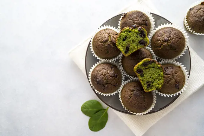 Spinach muffins. Healthy, vegan green muffins, top view. Copy space for text