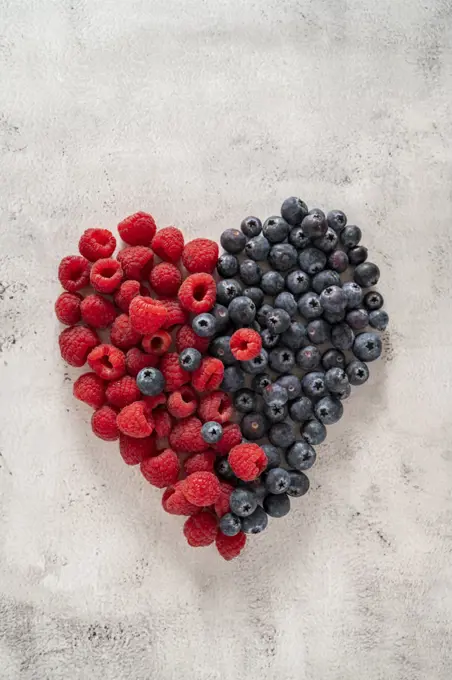 Raspberry and blueberry heart. Healthy food, nutrition and detox concept. Top view