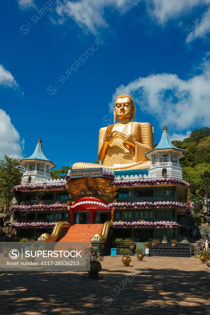 Dambulla, Sri Lanka - September 24, 2009: Golden Buddha temple with gold Buddha on roof, Dambulla, Sri Lanka. Golden Temple of Dambulla is a UNESCO World Heritage Site