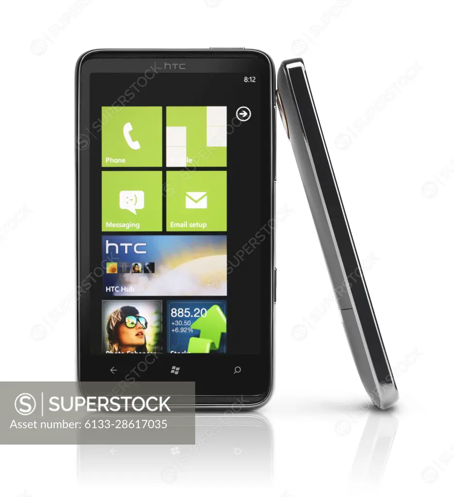 Two Windows 7 phones. HTC HD7 smartphone with desktop tiles on its display isolated with clipping path on white background. High quality photo.