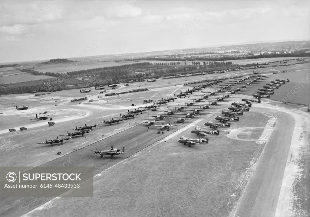 D-day - British Forces during the Invasion of Normandy 6 June 1944 Part of 6th Airlanding Brigade, 6th Airborne Division, waiting to leave RAF Tarrant Rushton on the evening of 6 June 1944. On the runway are Hamilcar heavy gliders, preceded by two Horsa troop-carrying gliders, while parked on each side of them are Handley Page Halifax glider-tugs of Nos. 298 and 644 Squadrons RAF.