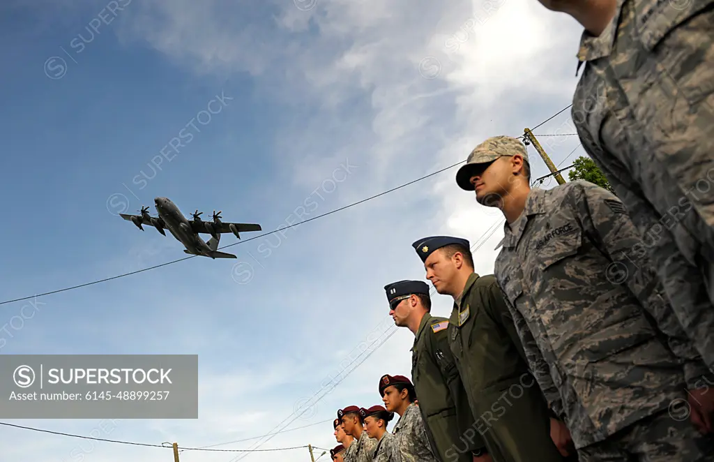 A C-130J Super Hercules aircraft flies over a formation of Airmen as they participate in a ceremony to remember veterans of World War II on the 70th anniversary of D-Day June 6, 2014, in Picauville, France. The event was one of several commemorations of D-Day operations conducted by Allied forces. The morning of June 6, 1944, Allied forces conducted a massive airborne assault and amphibious landing in the Normandy region of France. The invasion marked the beginning of the final phase of World War II in Europe, which ended with the surrender of Germany the following May.