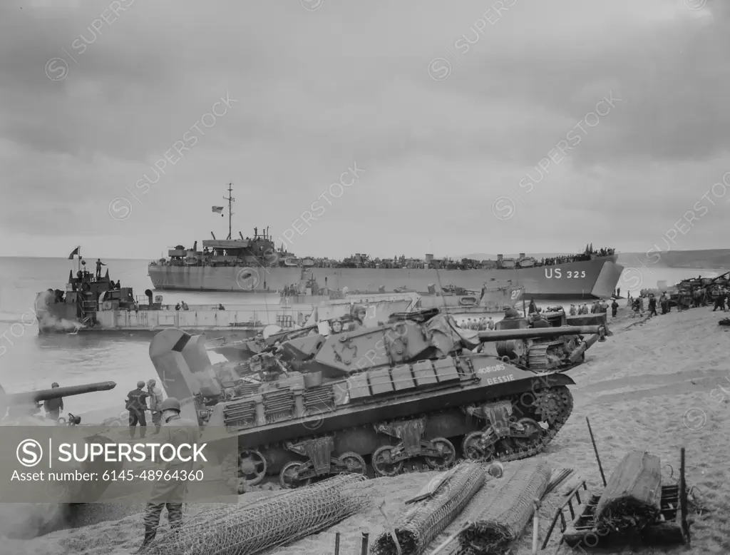 Photograph of Medium Tanks Unloading with LCT-153 and LST-325 in BackgroundArmy men loading landing craft with food supplies at an English port, in preparation for France invasion. Medium tanks unloading with LCT-153 and LST 325 in background. Pre D-day. 1943 - 1968.