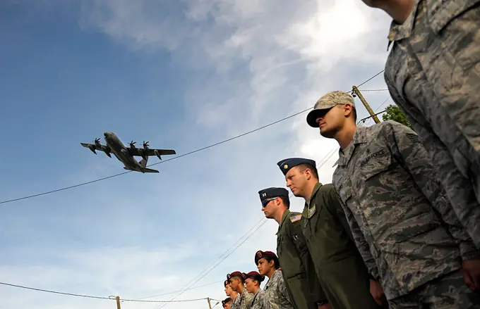 A C-130J Super Hercules aircraft flies over a formation of Airmen as they participate in a ceremony to remember veterans of World War II on the 70th anniversary of D-Day June 6, 2014, in Picauville, France. The event was one of several commemorations of D-Day operations conducted by Allied forces. The morning of June 6, 1944, Allied forces conducted a massive airborne assault and amphibious landing in the Normandy region of France. The invasion marked the beginning of the final phase of World War II in Europe, which ended with the surrender of Germany the following May.