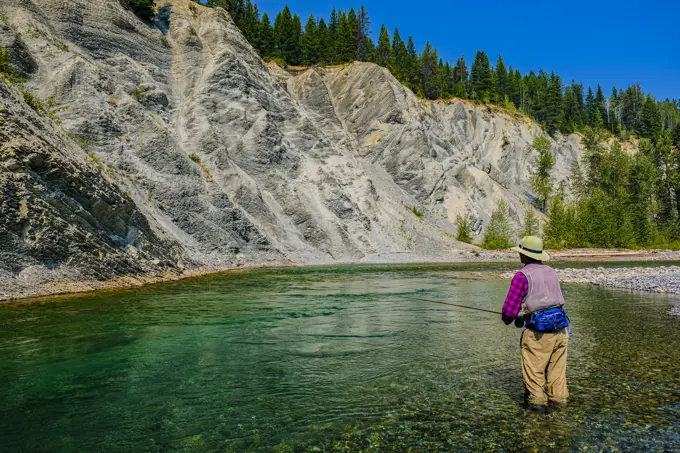 Fly Fishing for trout on the Bull River in the Canadian Rockies in August.