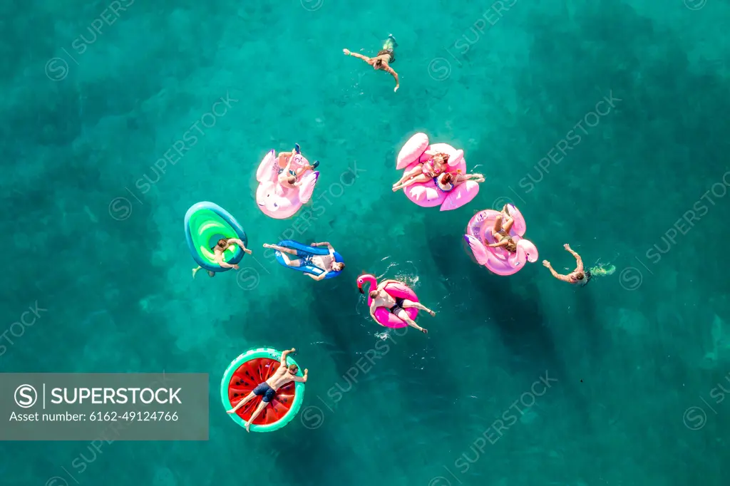 Tisno, Croatia - 9AUGUST 2019: Aerial view of people floating in the turquoise waters