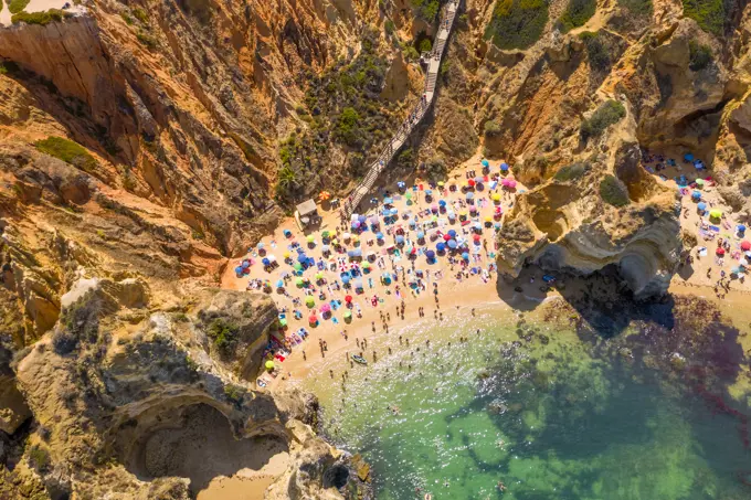 Aerial view of Praia do Camilo, hidden beach accessible by steep steps, Portugal.