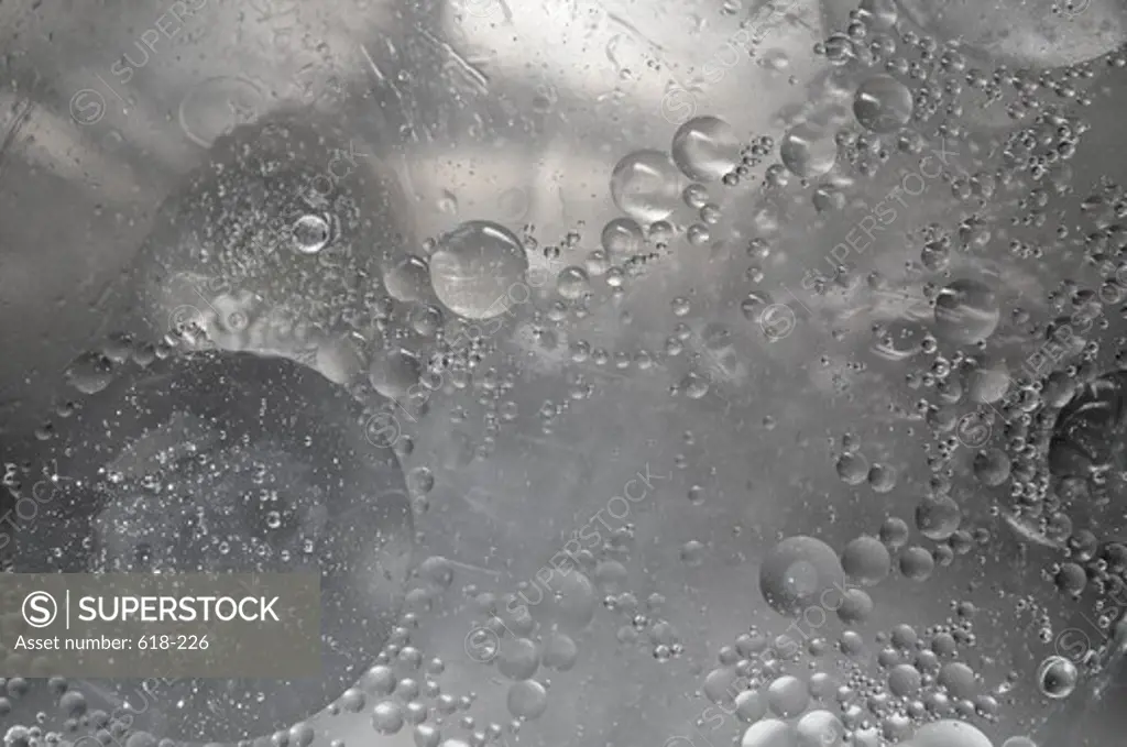 Almost colorless bubbles and drops randomly distributed in body of liquid