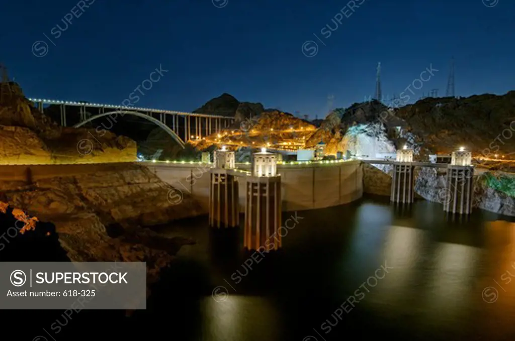 USA, Hoover Dam and US 93 bypass bridge at night, illuminated by rising full moon