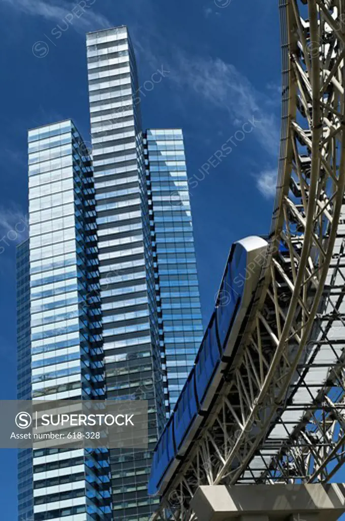 USA, Nevada, Las Vegas, Elevated track of automated people mover system at City Center against a backdrop of Vdara glass and steel tower