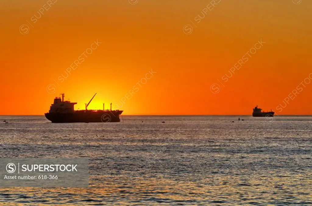 USA, California, Los Angeles, Westchester, Dockweiler Beach, Oil tankers at sunset