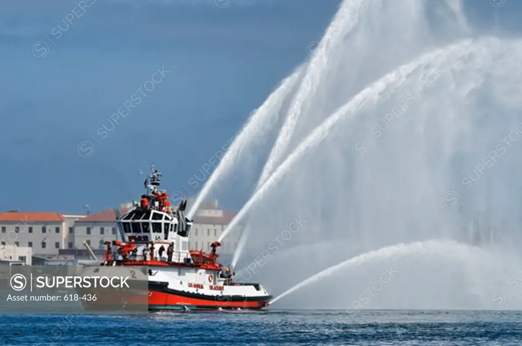 USA, California, San Pedro, Port of Los Angeles, One of Los Angeles Fire Department's fire fighting vessels shooting cascades of water into air