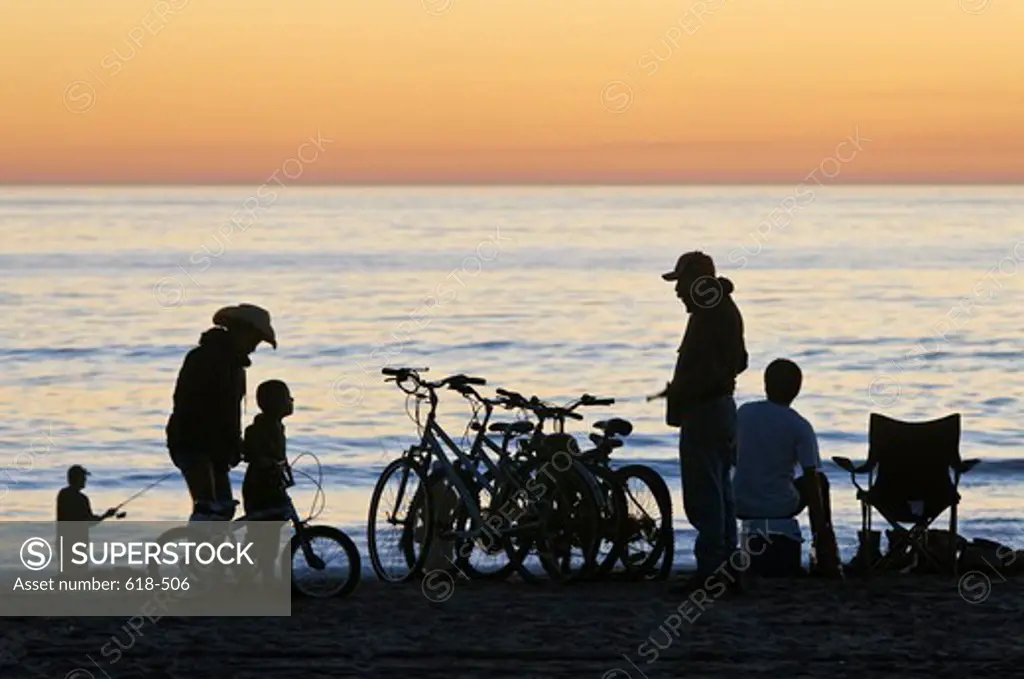 USA, California, Los Angeles, Westchester, Dockweiler Beach, People enjoying sunset on calm and warm evening along beach
