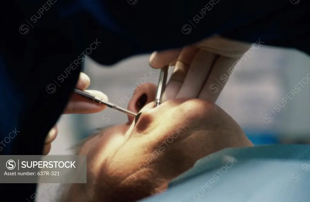 Male patient getting dental treatment