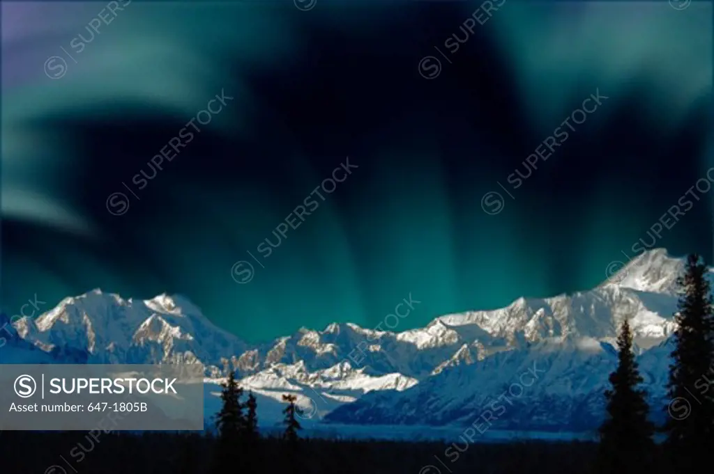 Aurora borealis over snow covered mountains, Mount McKinley, Denali National Park, Alaska, USA