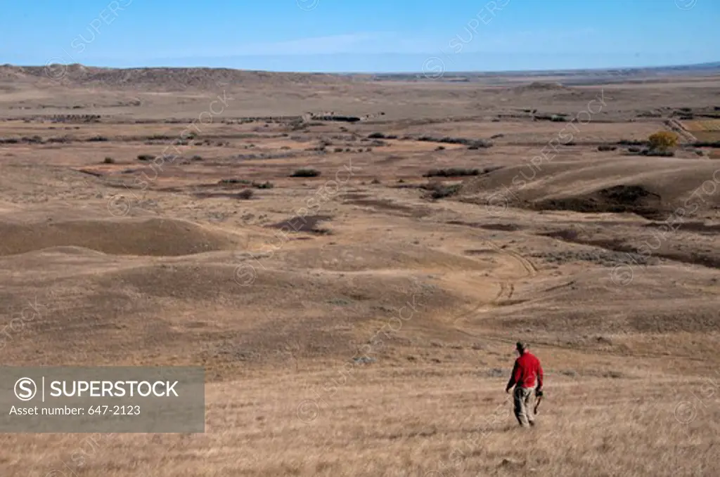 Man hiking in a desert, Grasslands National Park, Saskatchewan, Canada