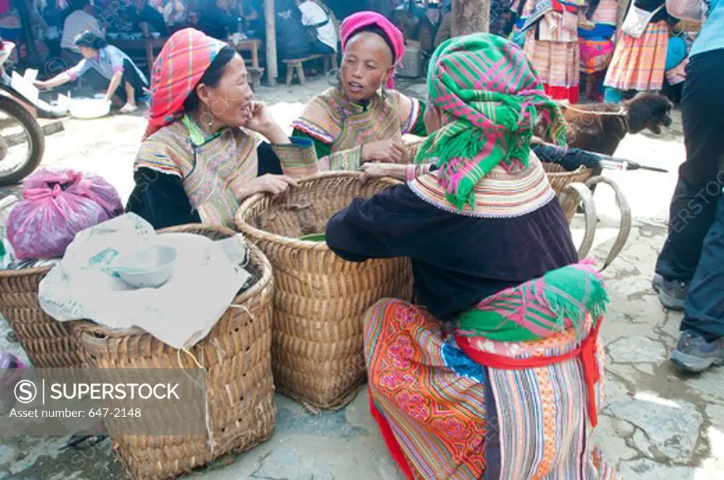 Mature women in traditional clothing at a market, Bac Ha Market, Vietnam