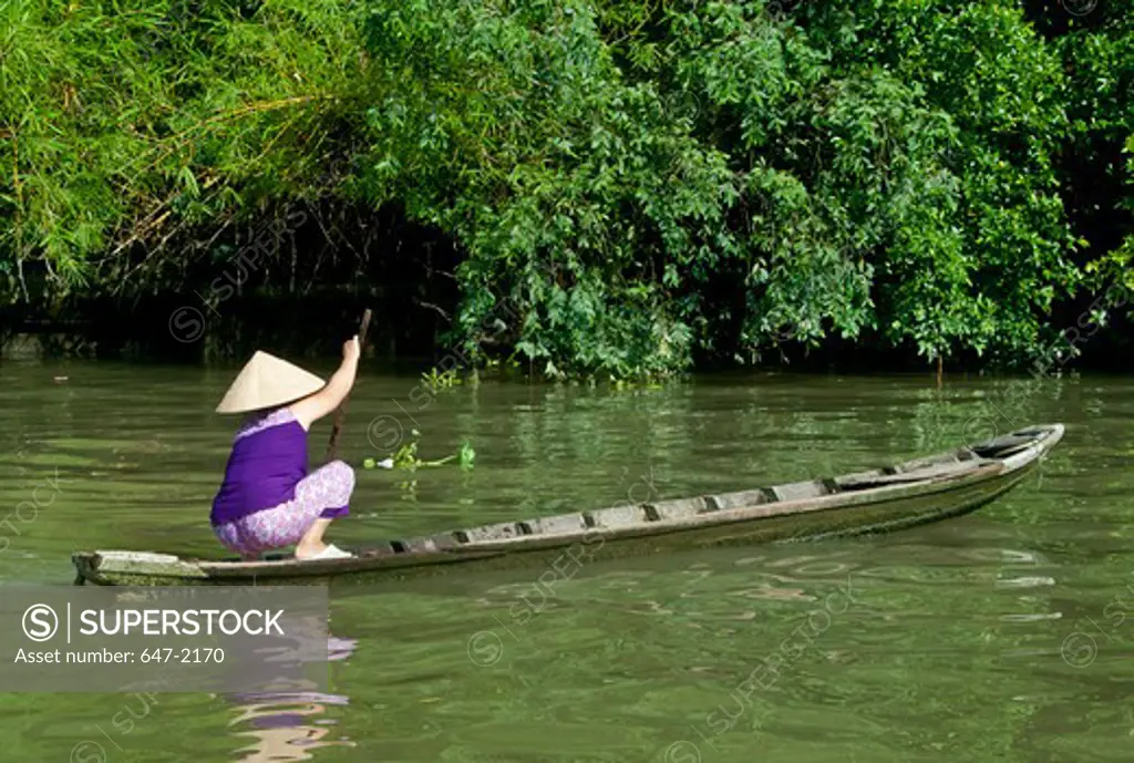 Person rowing a boat in the river, Mekong River, Vietnam