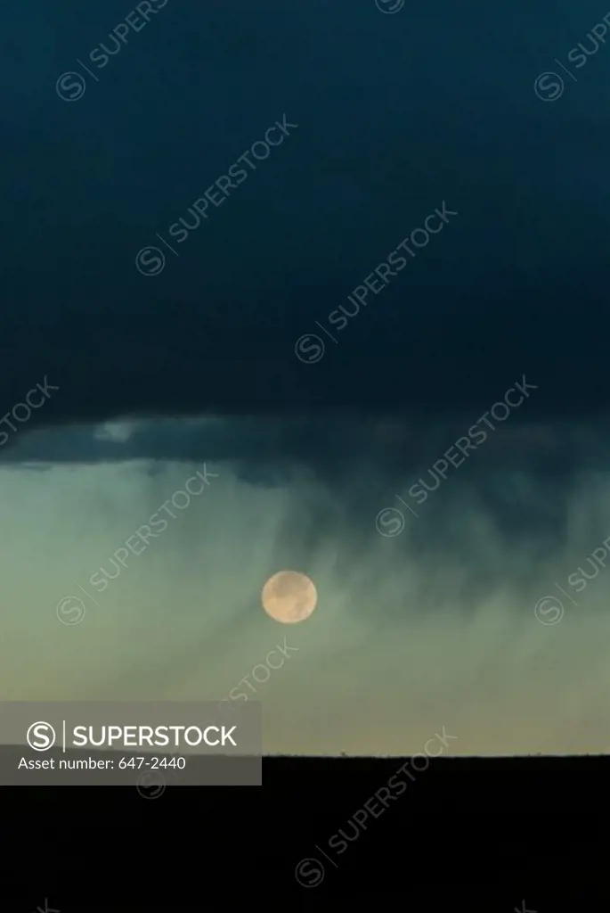 Rainclouds with moon beneath. South Dakota
