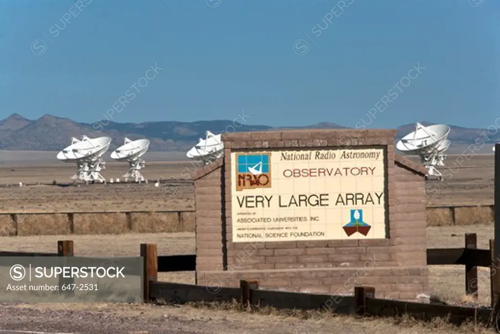Signboard in a field with telescopes in the background, Very Large Array, National Radio Astronomy Observatory, Socorro, New Mexico, USA