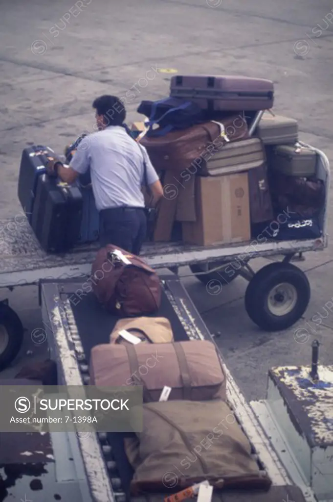 Man unloading luggage at an airport