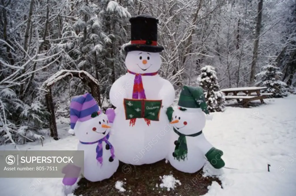 Three snowmen on snow