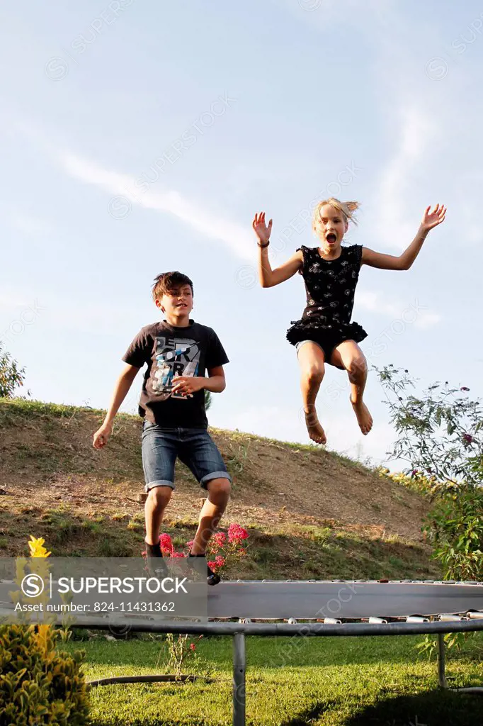 Children playing on a trampoline.