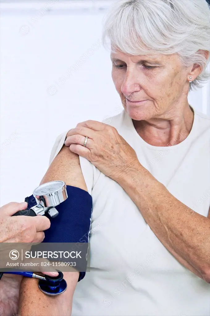 doctor measuring patient's blood pressure.